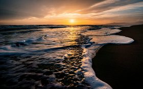 Amazing beach with waves and a sunset in Marina di Grosseto, Italy